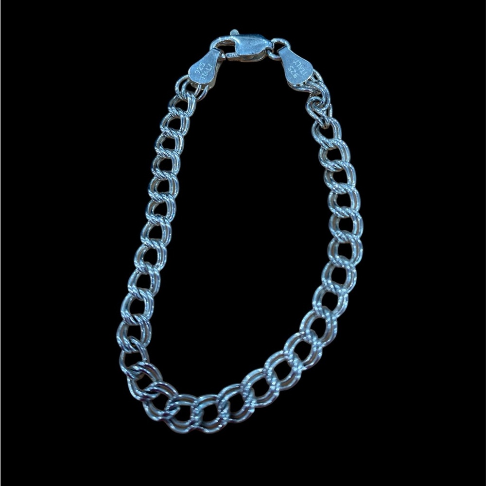 Beautiful 6’inch  925 sterling silver charm bracelet.Great with any outfit.